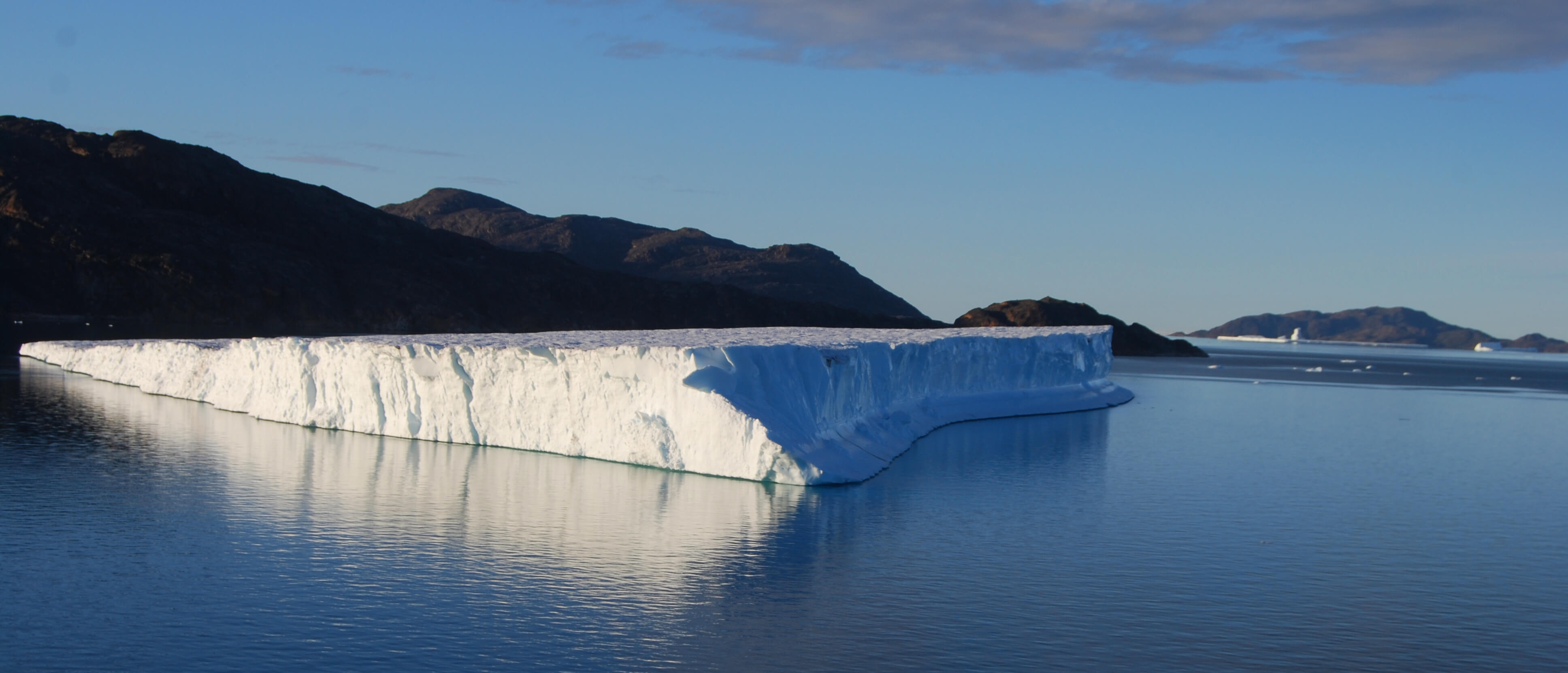 Iceberg slowly drifting out of the fjord carrying fresh water into the Baffin Bay - Sentinel North international phd school